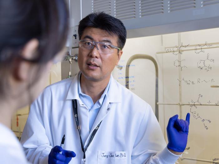 Faculty member working with student in chemistry lab