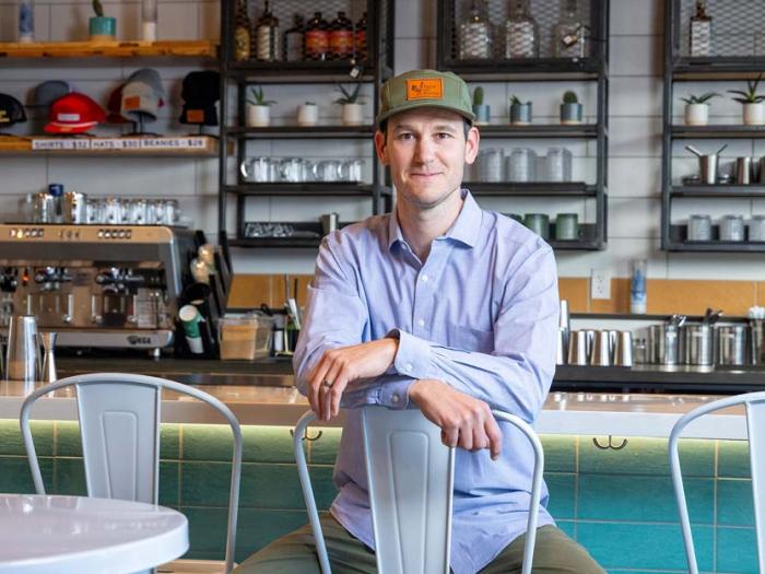 CU Denver MBA alum, Matias, sitting in his Denver based restaurant Taco Uprising