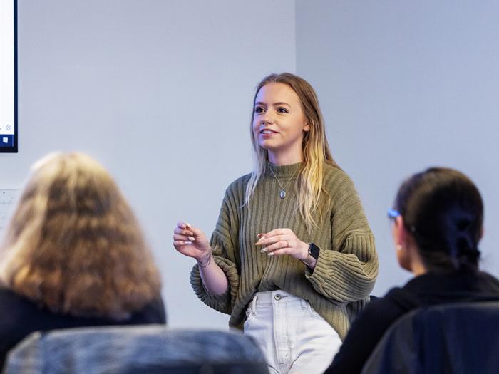 CU Denver student giving presentation in front of class