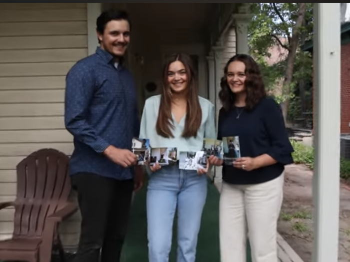 Three siblings, recipients of the Displaced Aurarian Scholarship, holding old family photos standing on porch