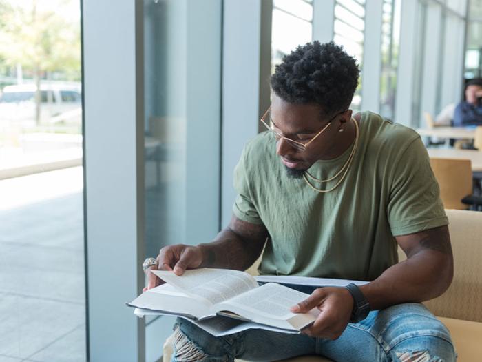 Student looking through textbook
