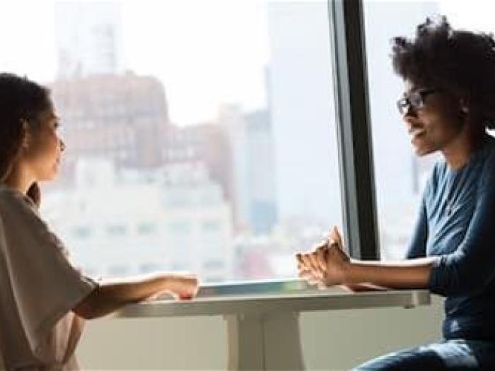 Two people talking at a table