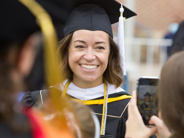 CU Denver student in regalia at commencement