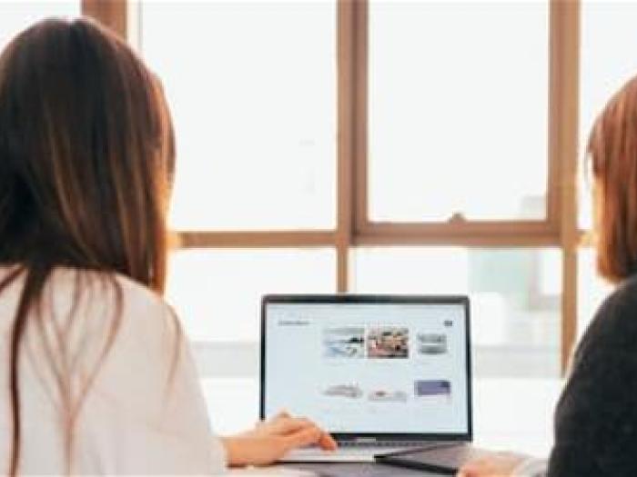 Two people looking at computer screen