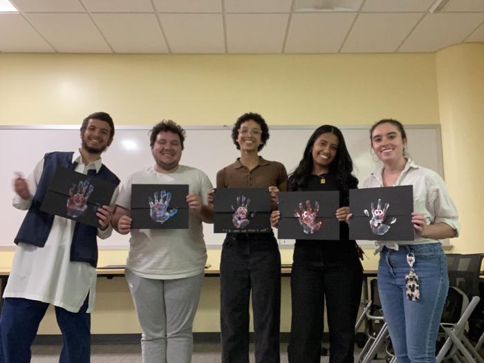 students-holding-certificates-with-handprint
