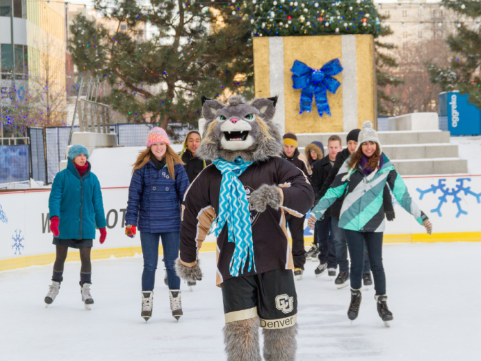 students ice skating with Milo the mascot