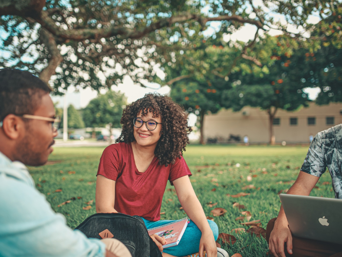 students sitting in grass