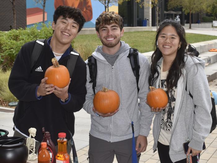 students-holding-pumpkins
