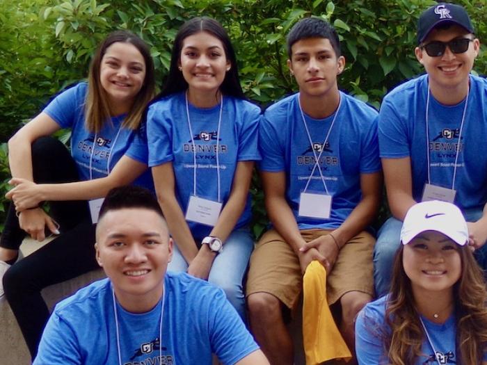 A group of CU Denver pre-college students wearing matching blue shirts
