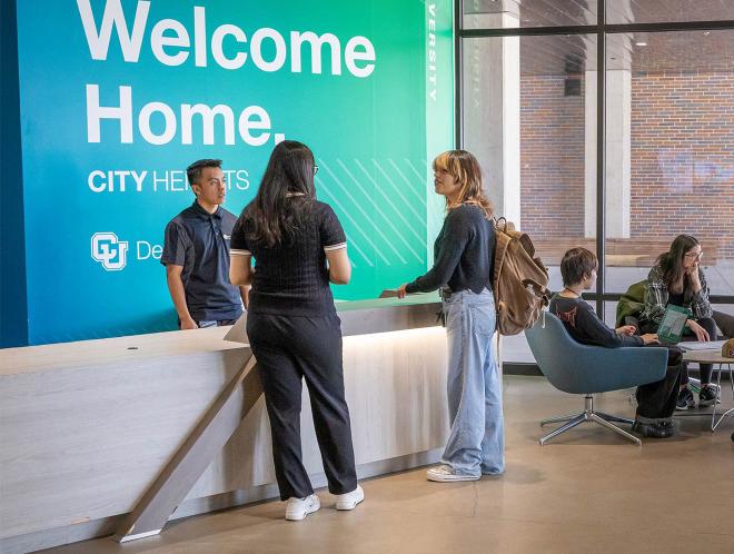 Students standing at counter in lobby of city heights