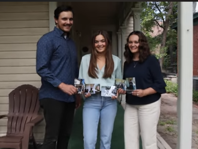 Three siblings, recipients of the Displaced Aurarian Scholarship, holding old family photos standing on porch