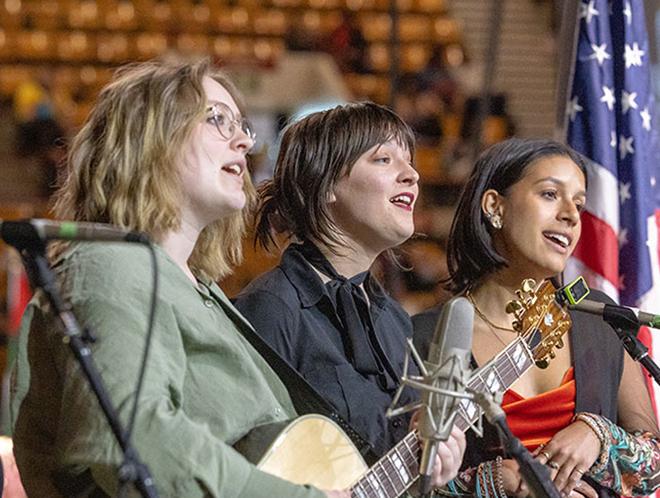 Three CU Denver students singing the alma mater at commencement