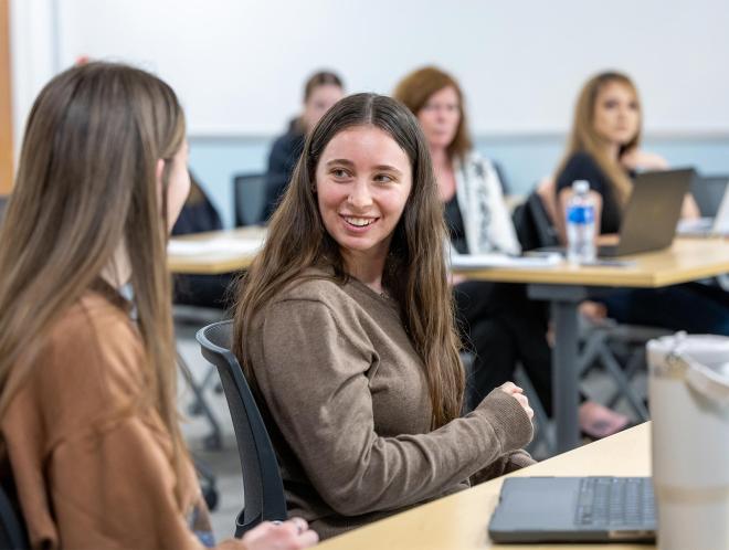 Two students talking in class