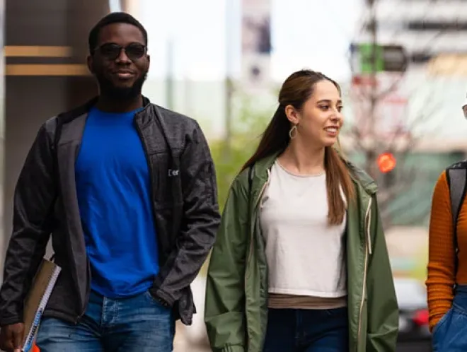 Three CU Denver students walking down street