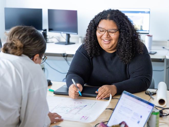 CU Denver student working on architecture drawings in classroom
