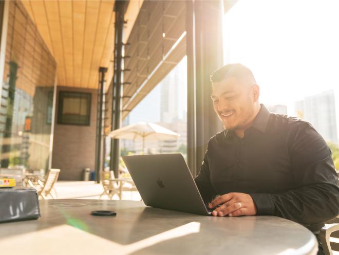 Student working outside on laptop