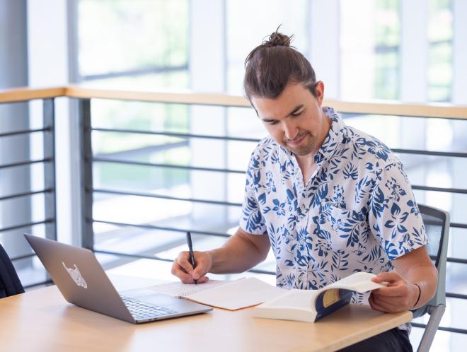 Student working on laptop indoors