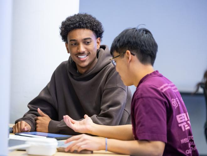 Two CU Denver students working in a classroom