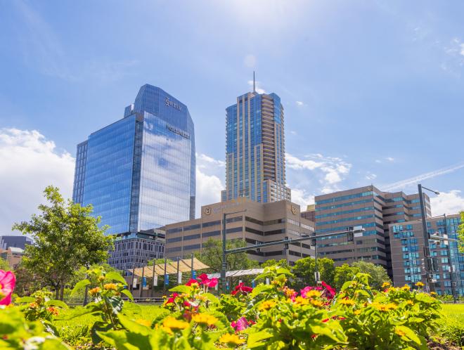Flowers in front of CU Denver buildings in front of skyscrapers
