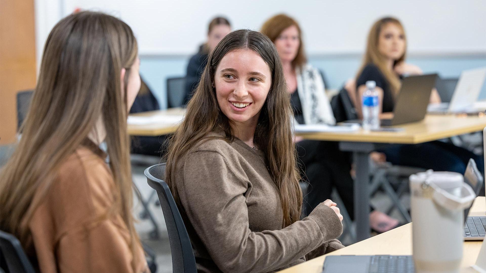 Two students talking in class
