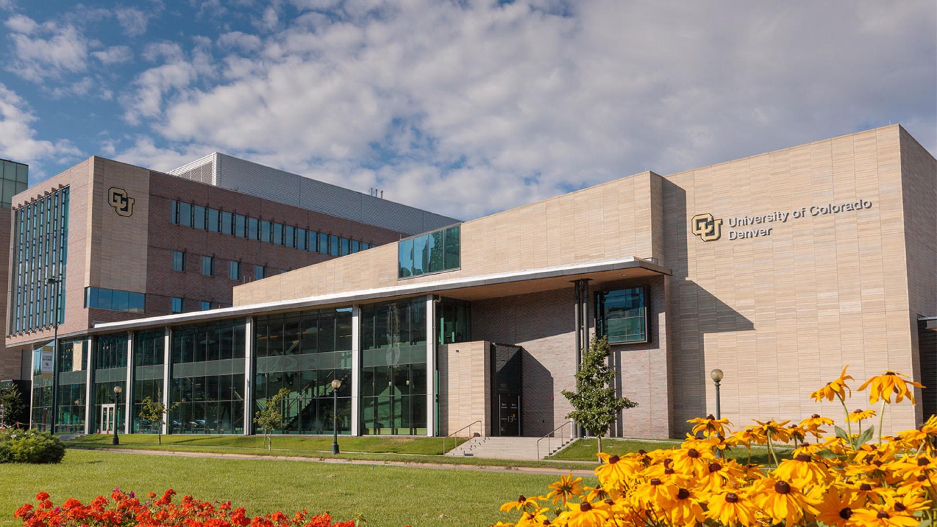 CU Denver buildings with red and yellow flowers in front of building