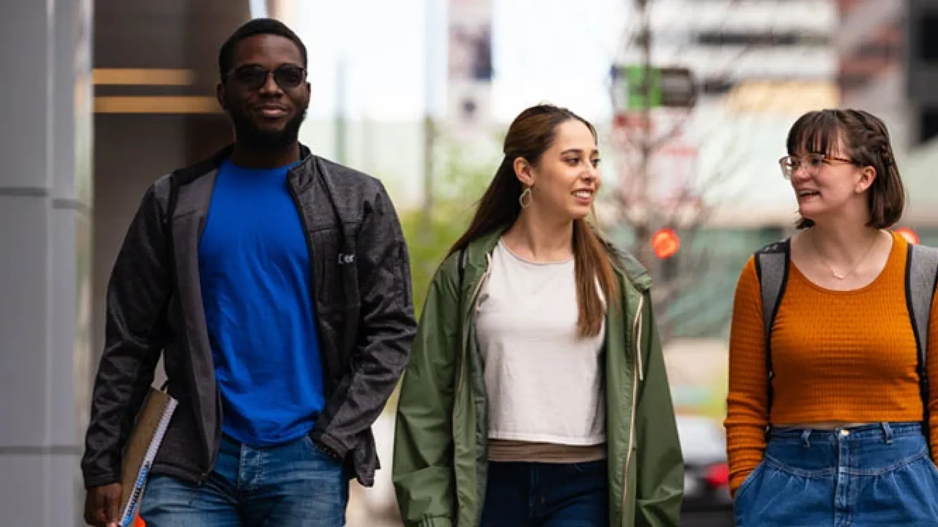 Three CU Denver students walking down street