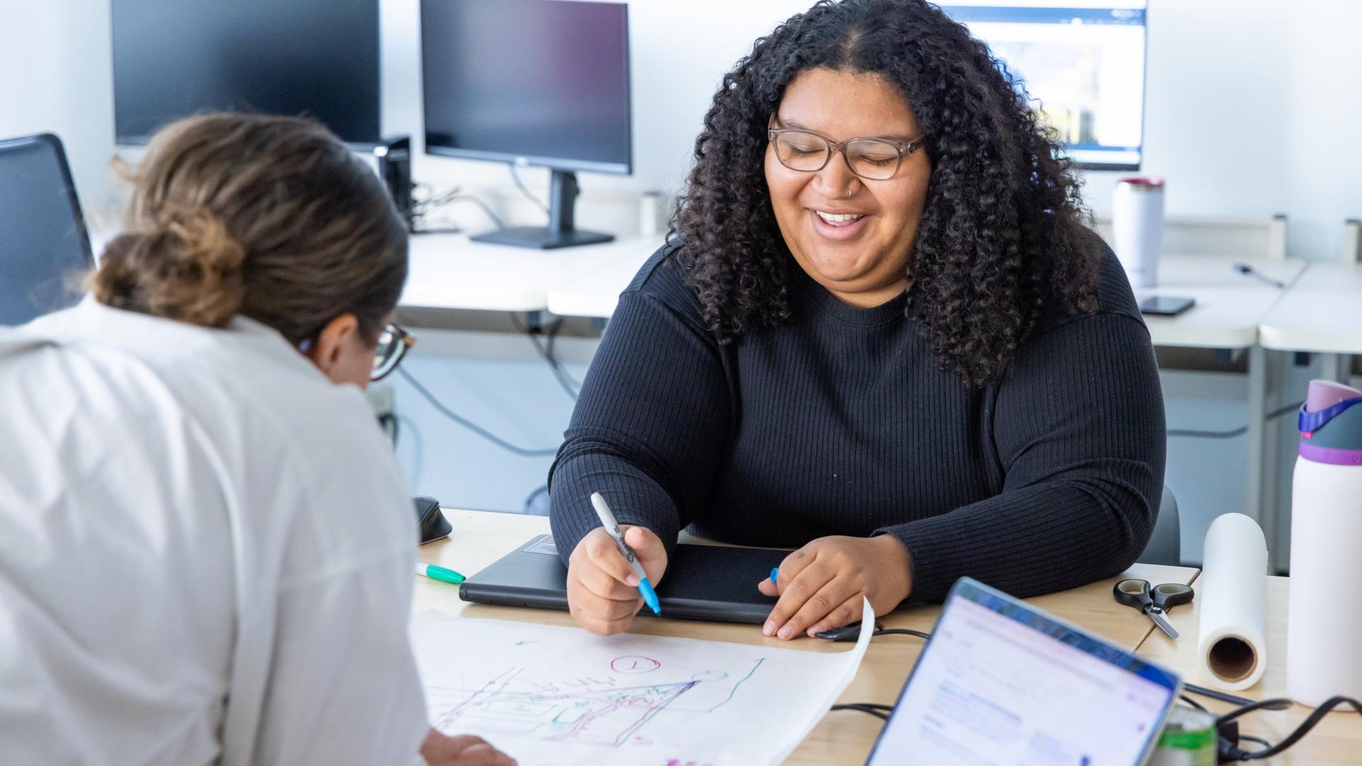 CU Denver student working on architecture drawings in classroom