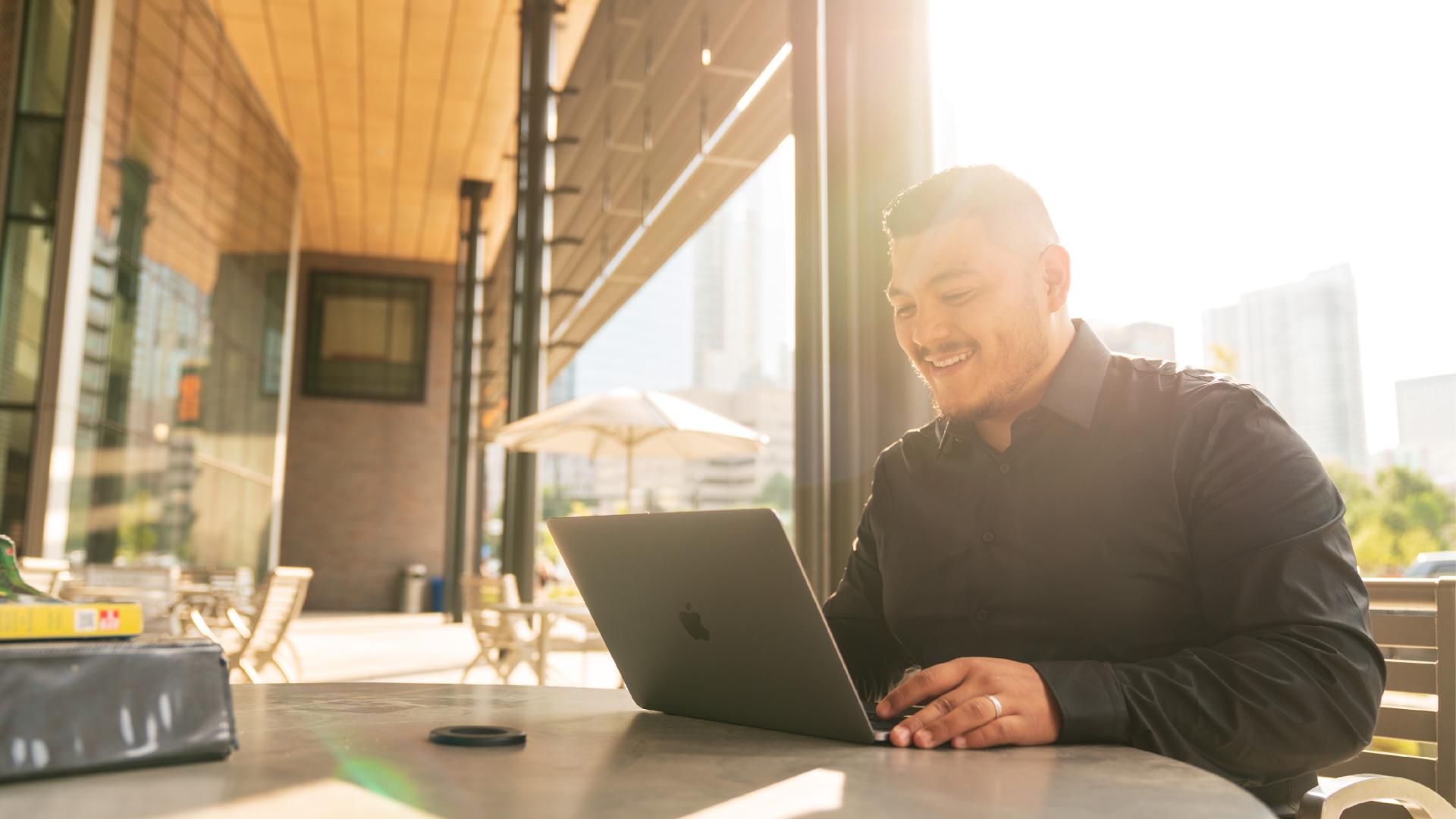 Student working outside on laptop