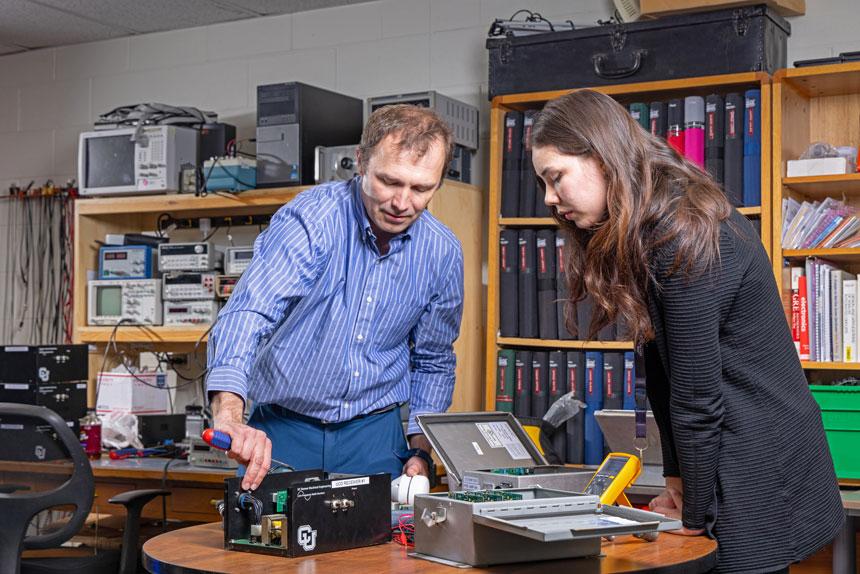 CU Denver student and professor in electronics setting