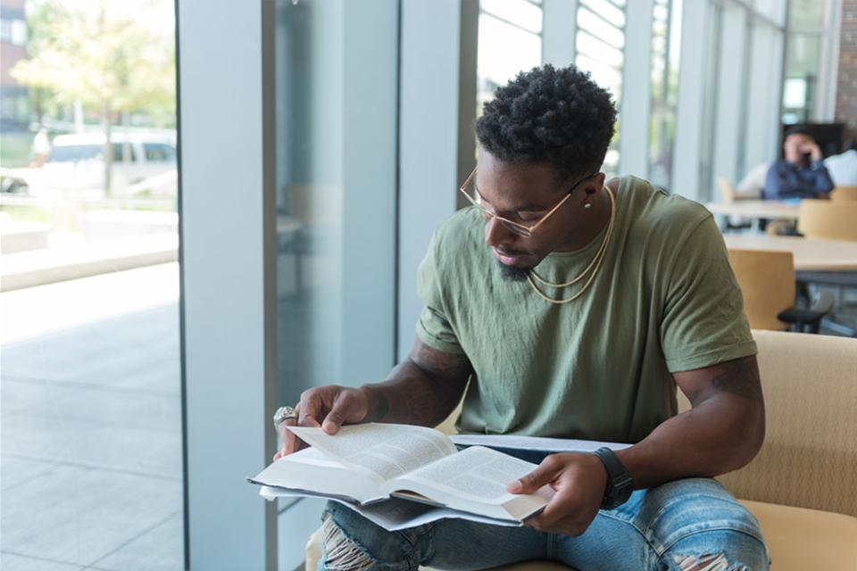Student looking through textbook
