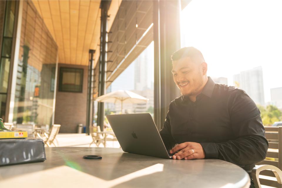 Student working outside on laptop