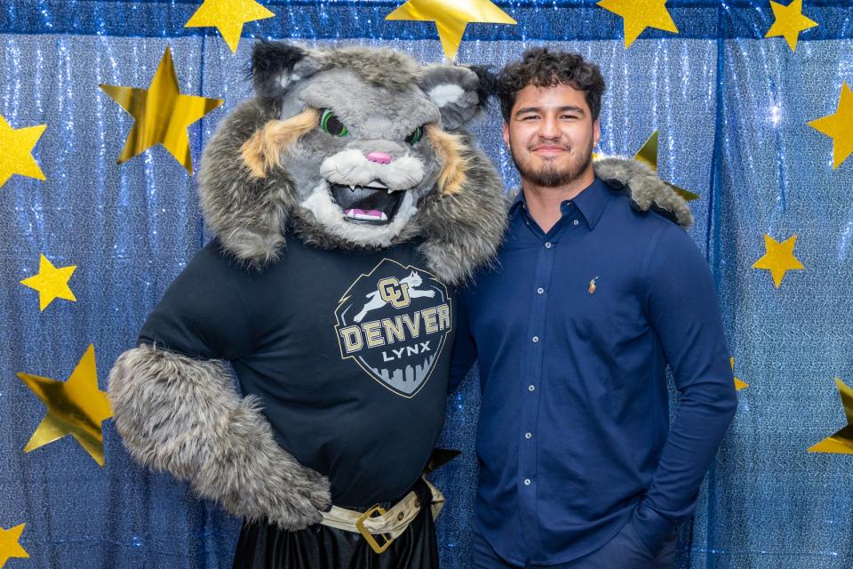 Milo the mascot posing with a student