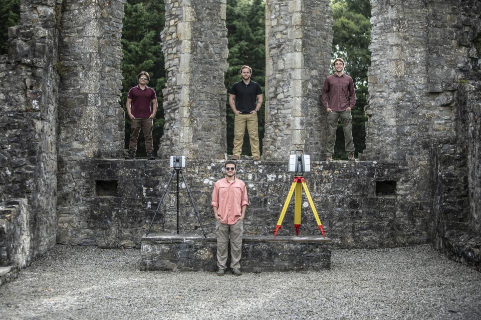 CU Denver students stand in the Trim Castle alongside the technology used to take scans.