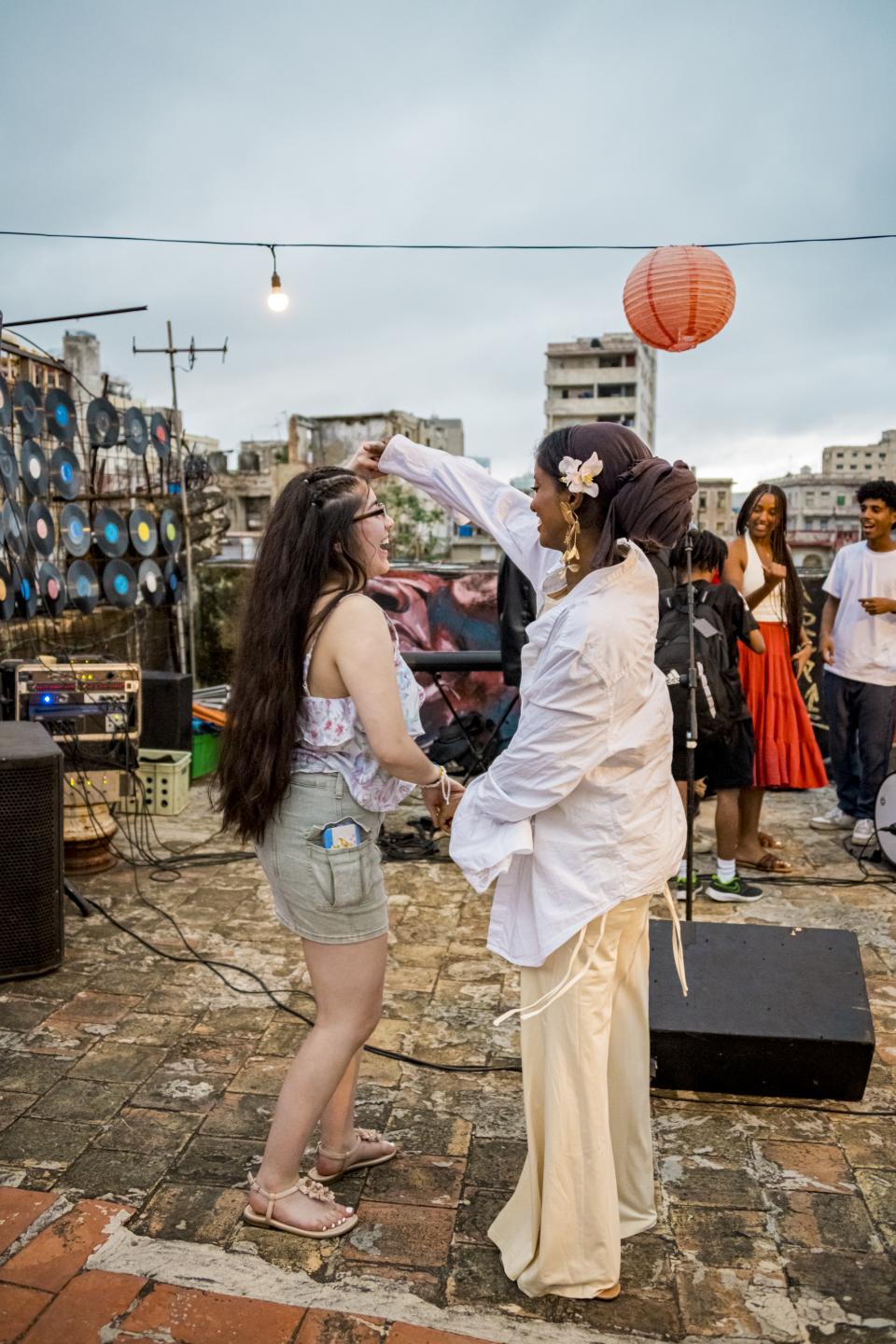 Two students dancing on a rooftop