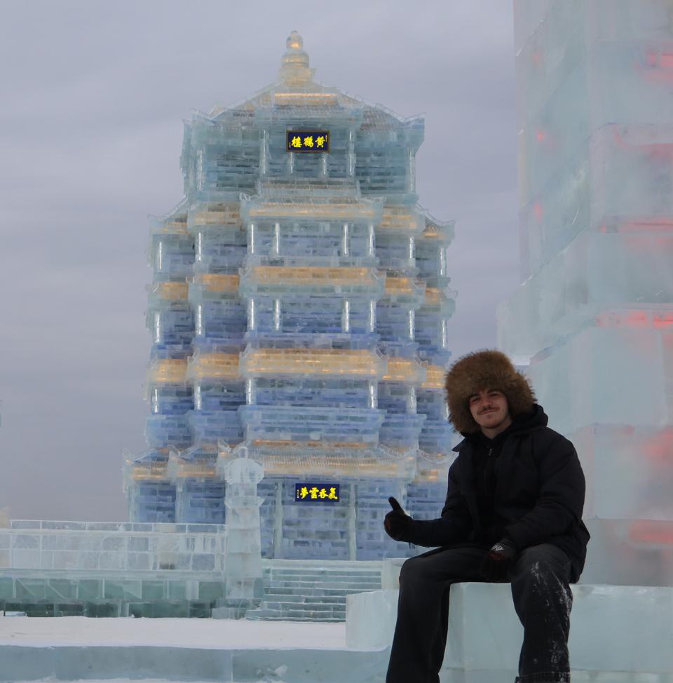 Student in front of the Yellow Crane Tower at Harbin Ice and Snow World.