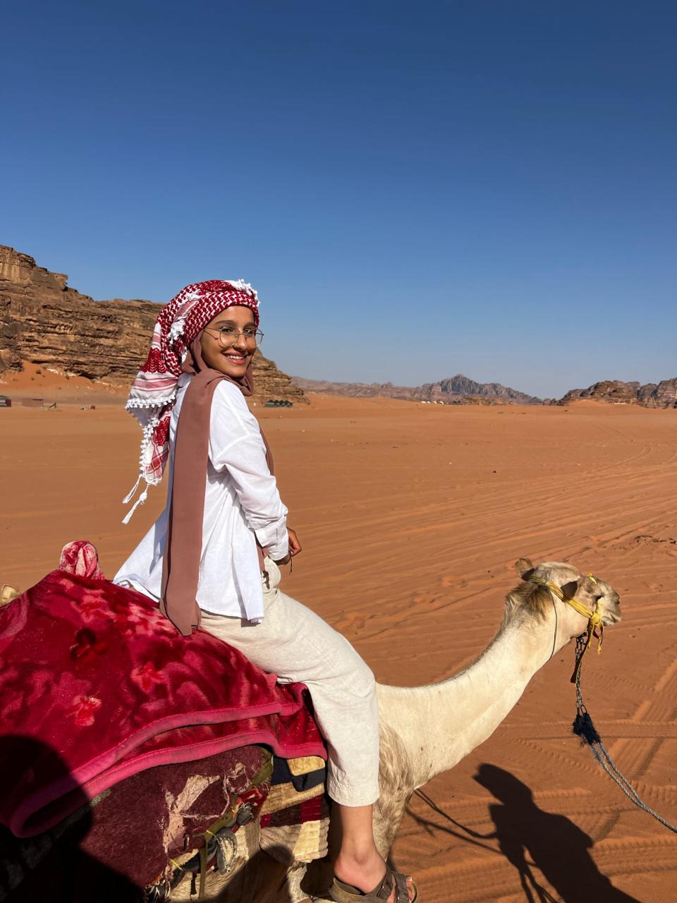 Student riding a camel