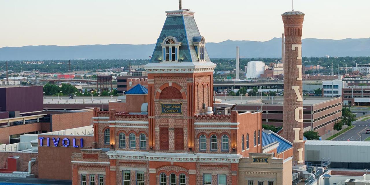 Aerial shot of Tivoli building with Rocky Mountains on the Horizon