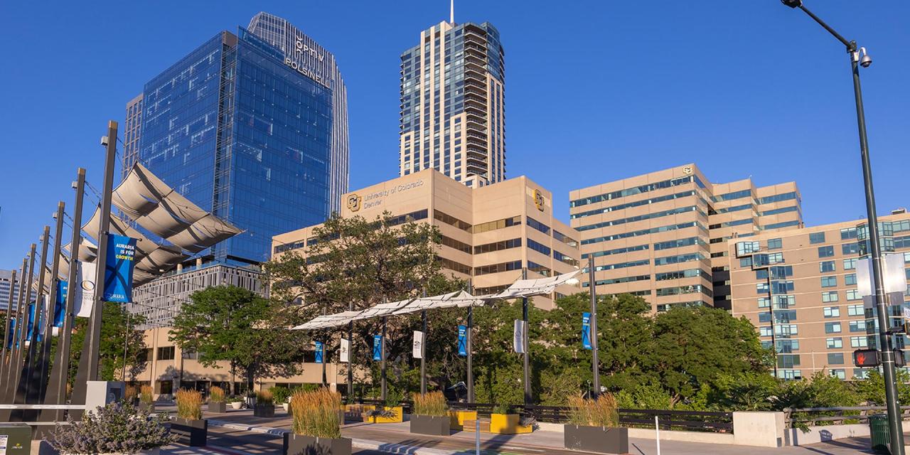View from ground looking up at CU Denver buildings surrounded by the city of Denver