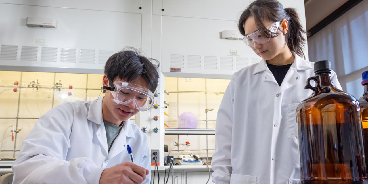 Two students working on project in science lab.