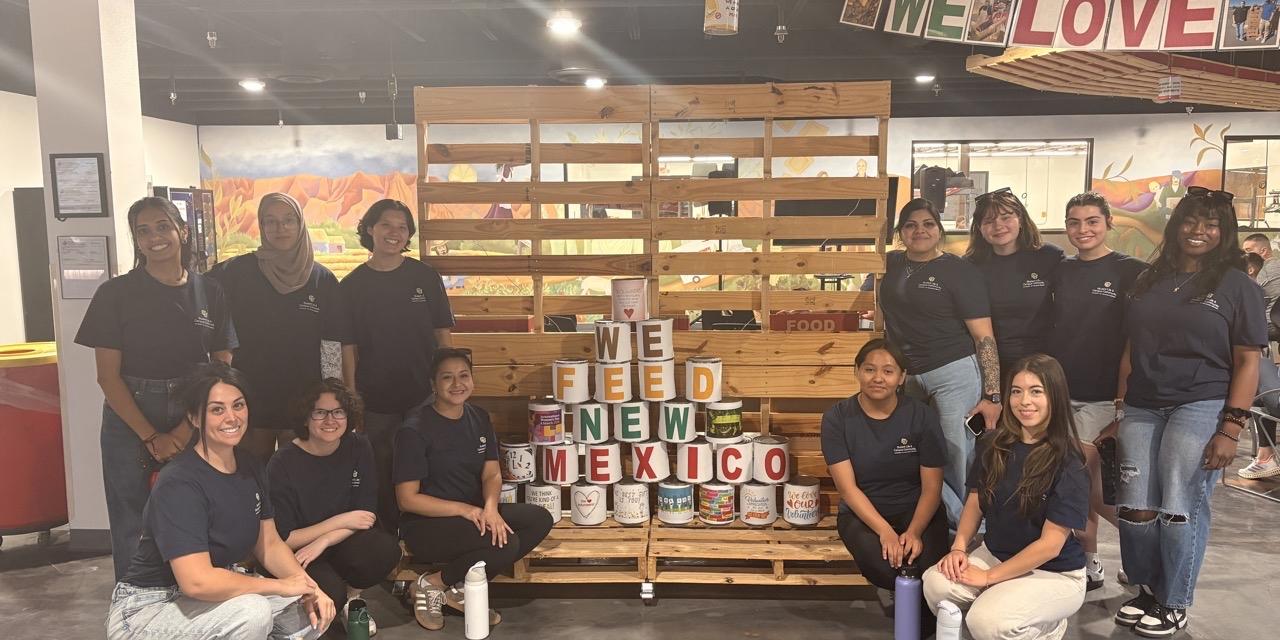 students-stand-in-front-of-cans