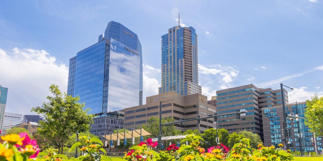 CU Denver campus photo in Spring with the city skyline in the background.