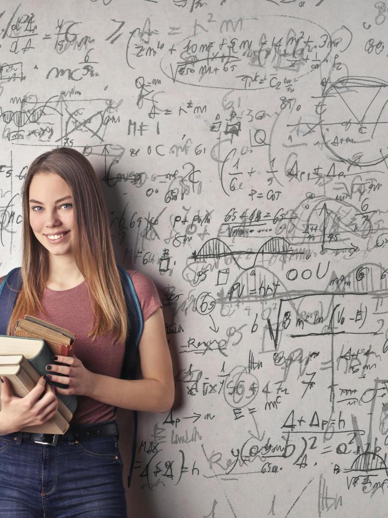 Student in front of chalkboard