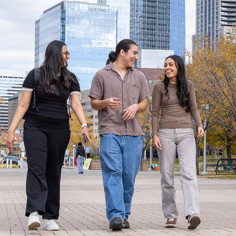 Three CU Denver walking on sidewalk 