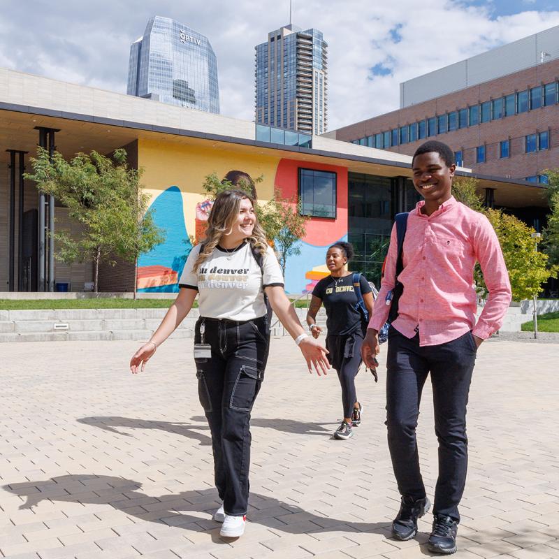 Students walking between buildings with Student Center in background