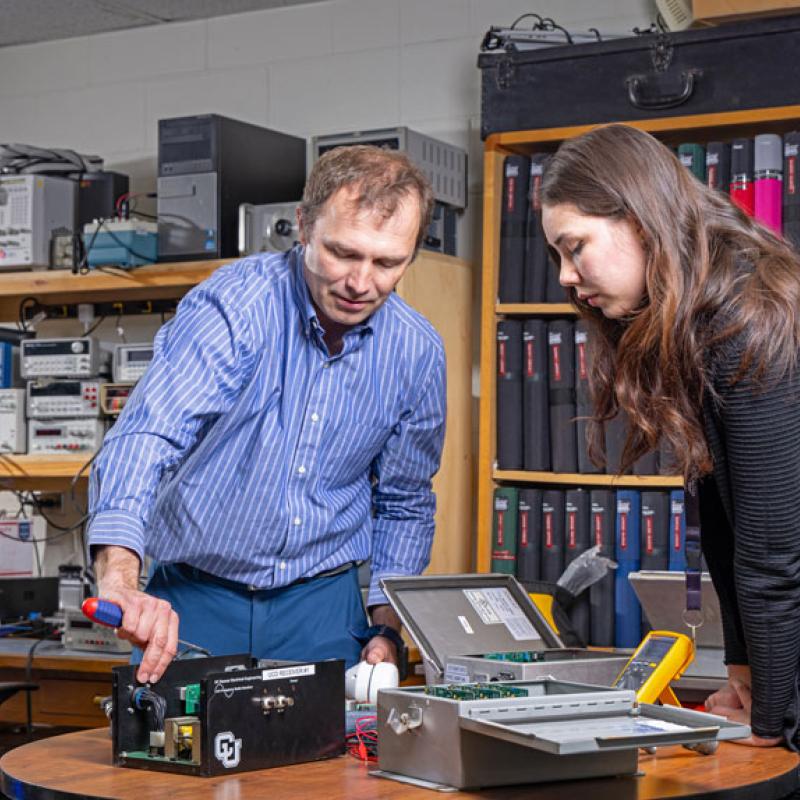 CU Denver student and professor in electronics setting