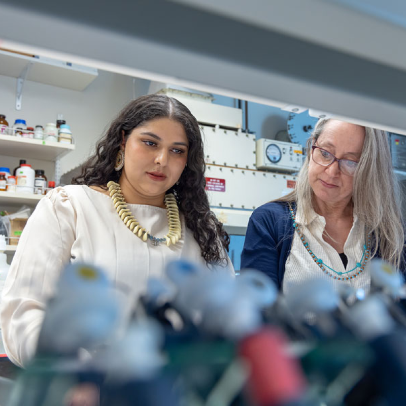 CU Denver student working in biology lab with faculty member