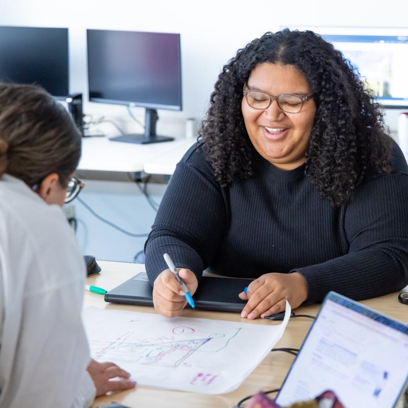 CU Denver student working on architecture drawings in classroom
