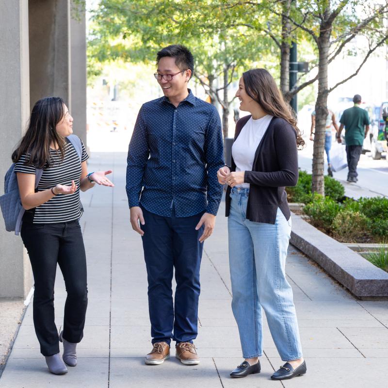 Professionals standing on sidewalk in downtown Denver