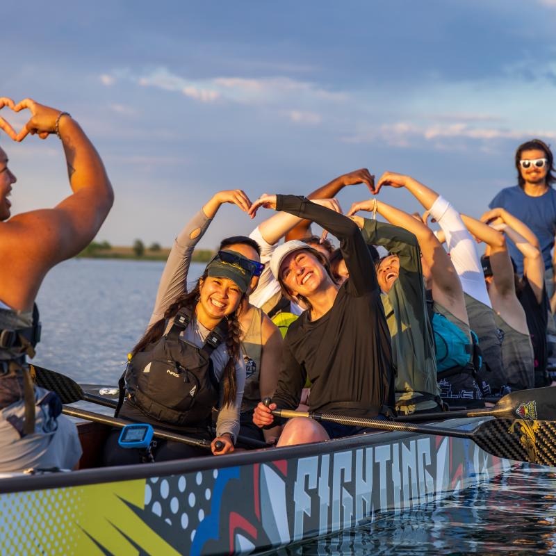 Students in voyageur canoe on lake