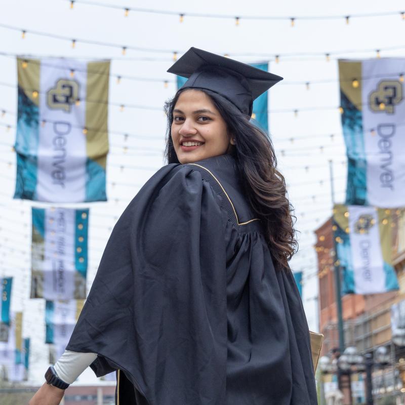 CU Denver graduate wearing regalia in Larimer Square